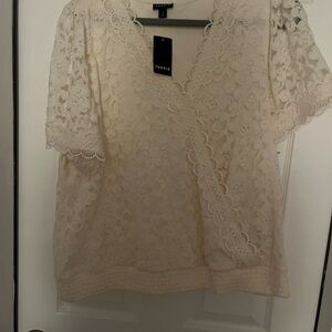 Torrid lace top with sleeves. Cream lace and gathered waist. NWT